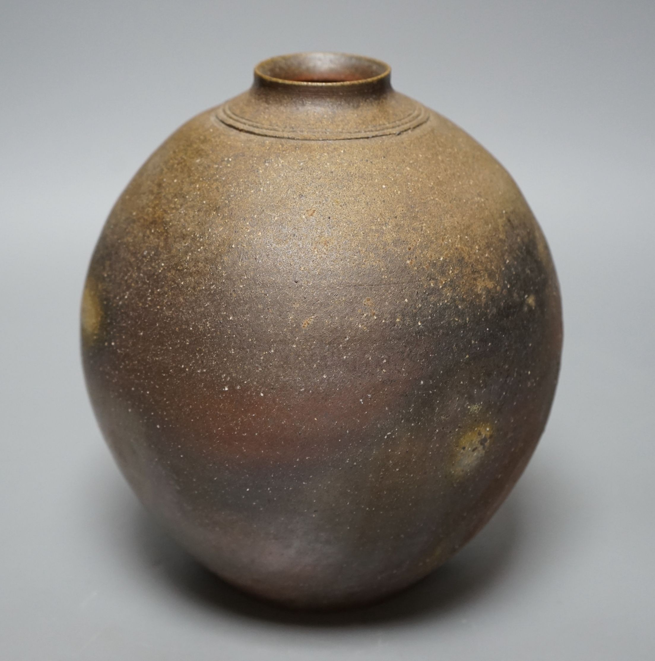 Japanese studio pottery: a boxed black glaze stoneware unomi tea bowl, with impressed mark, together with a ovoid vase, marked, 21cm tall